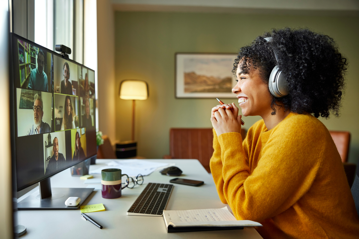 image of woman with headphones on zoom work call